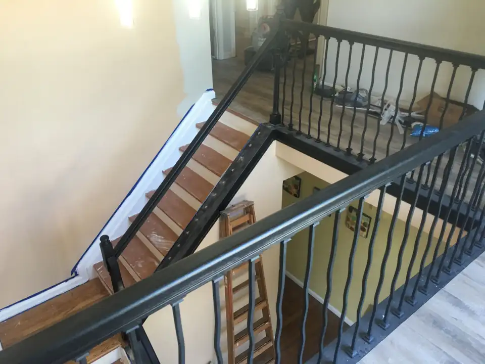 Staircase with new black metal railings, an ARC interior project