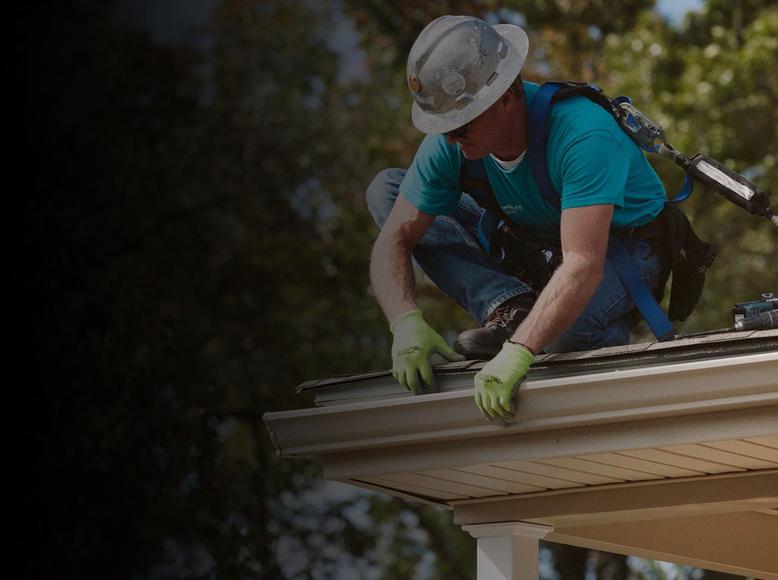 Installer fitting new gutters on a roofline